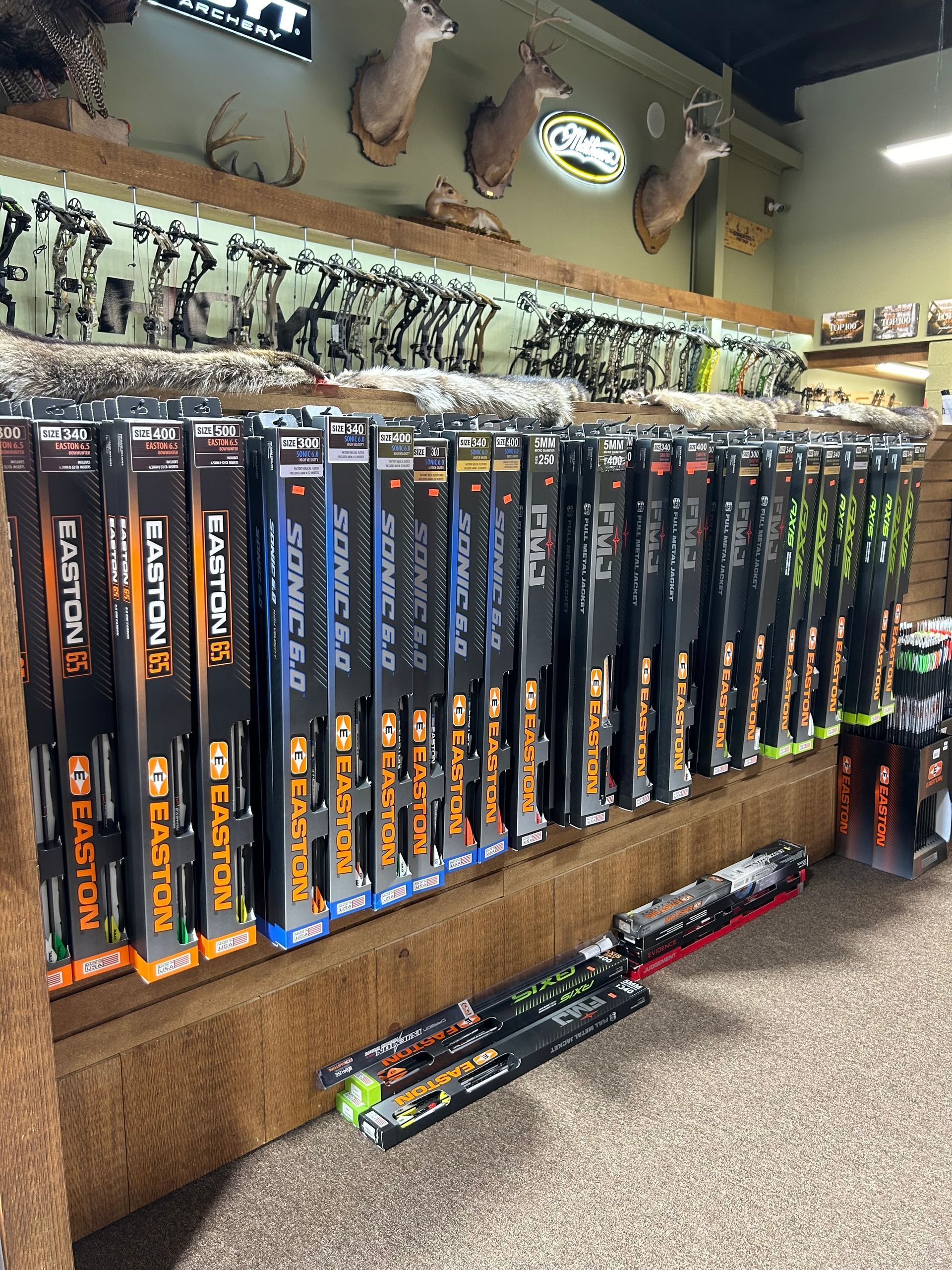 a bunch of fishing rods are lined up on a shelf in a store