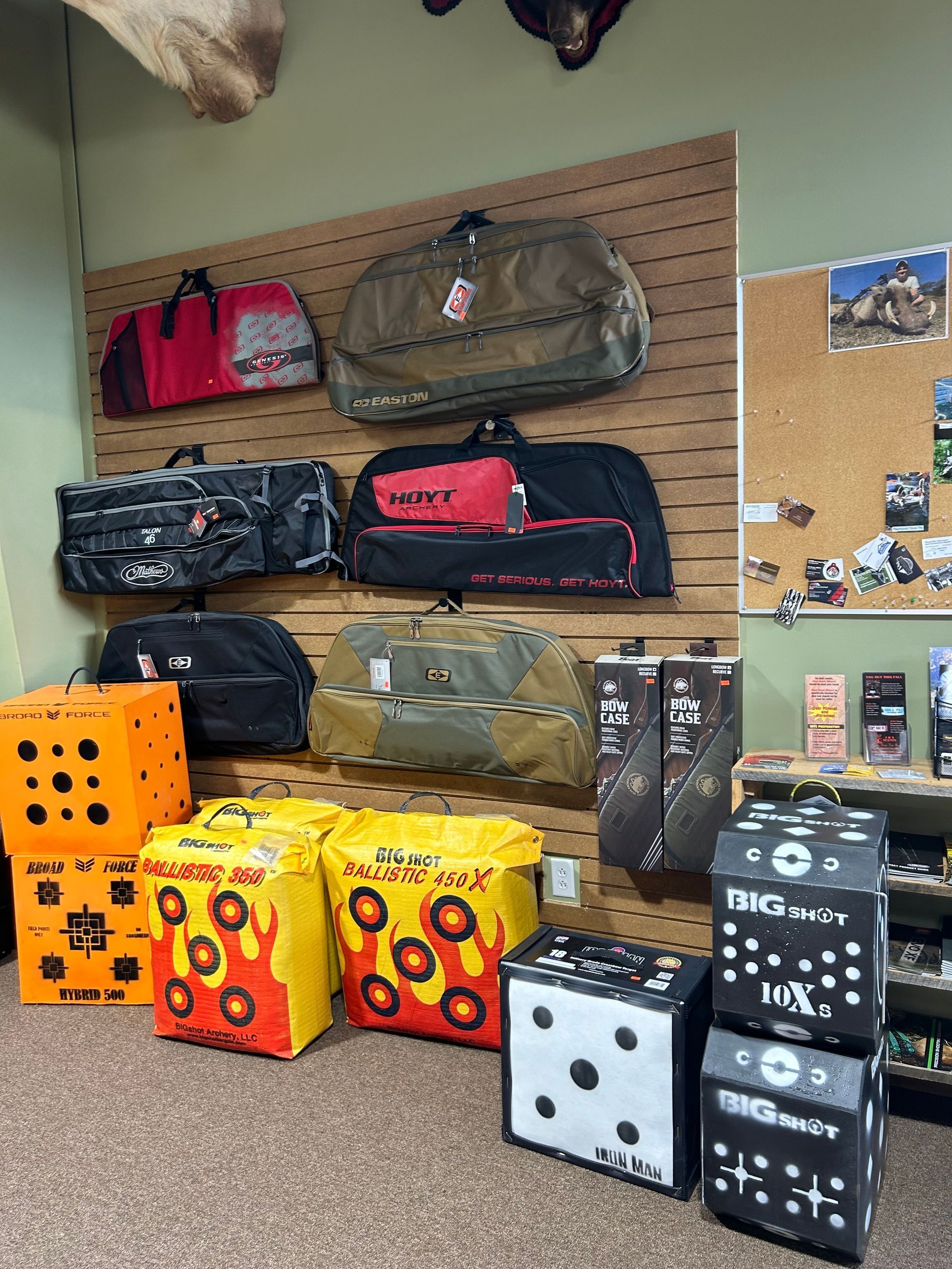 a bunch of bags are hanging on a wall in a room