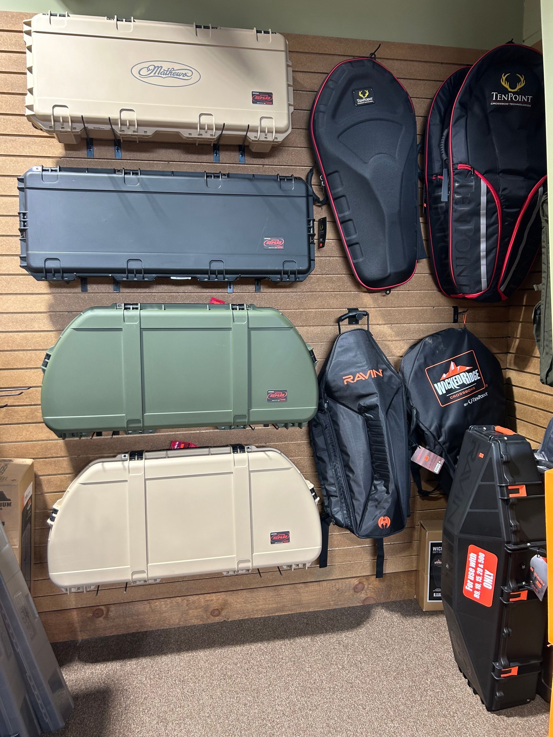 a bunch of cases are hanging on a wall in a room