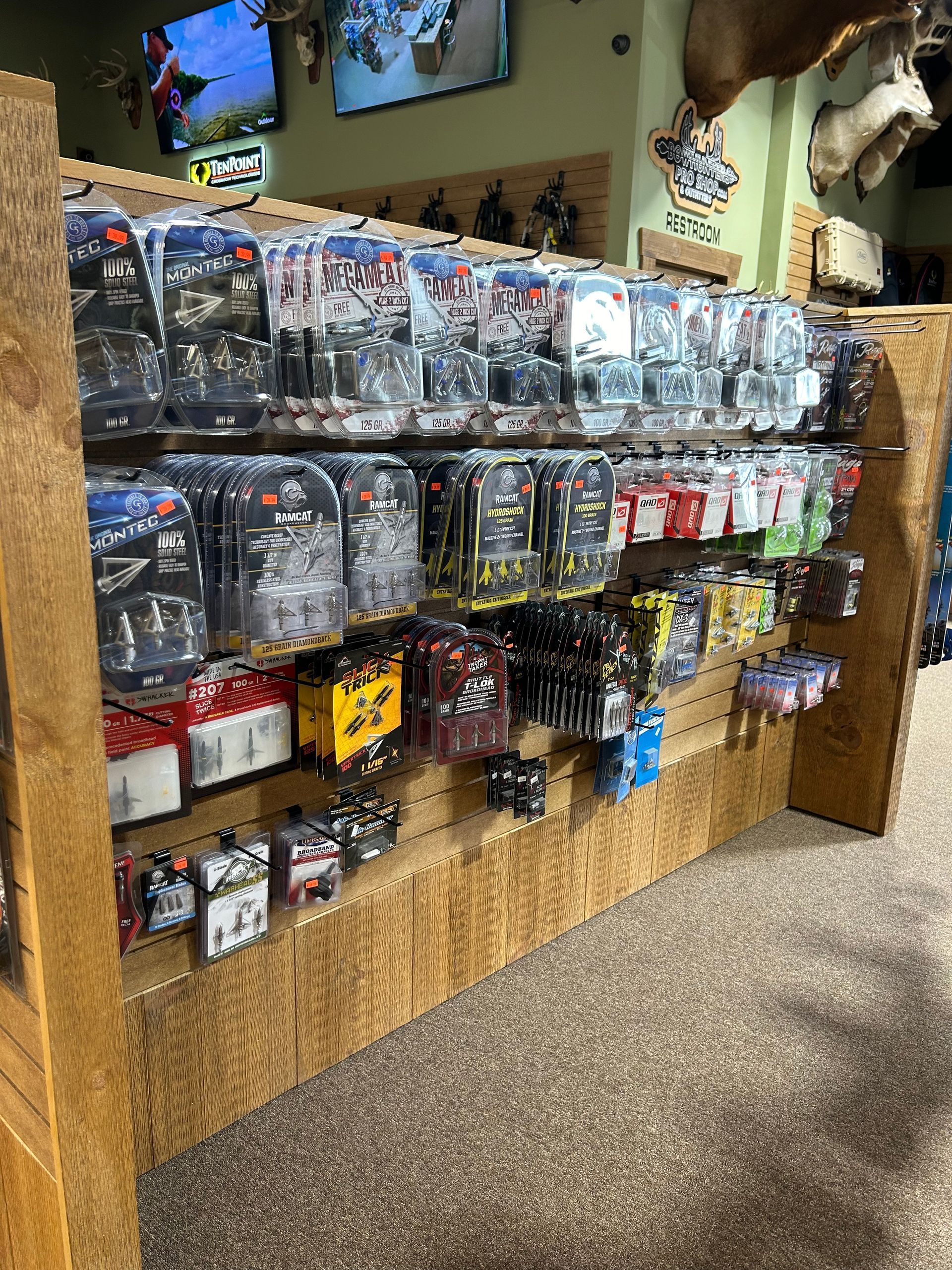 a shelf filled with lots of hunting equipments
