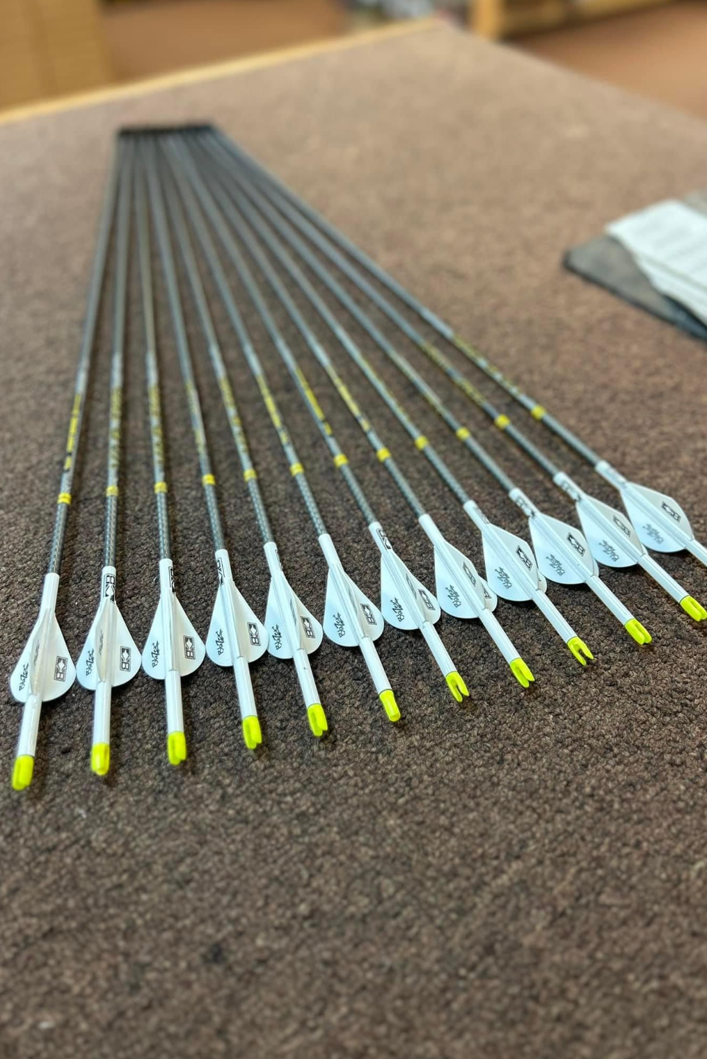 a bunch of arrows are lined up on a table