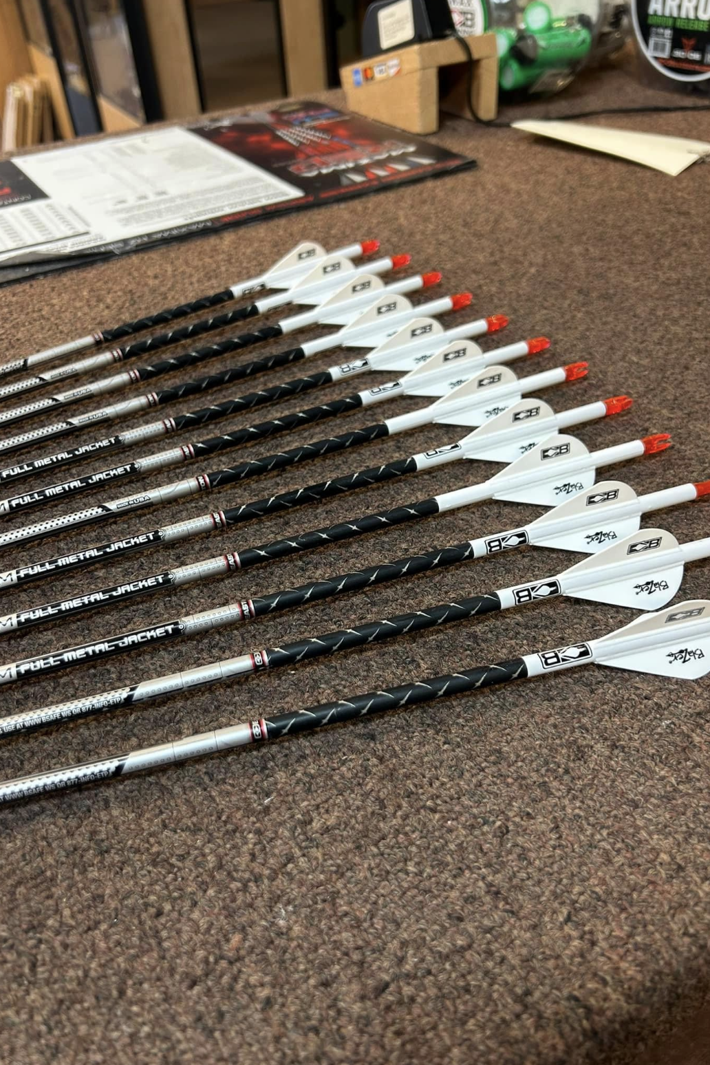 a bunch of arrows are lined up on a table