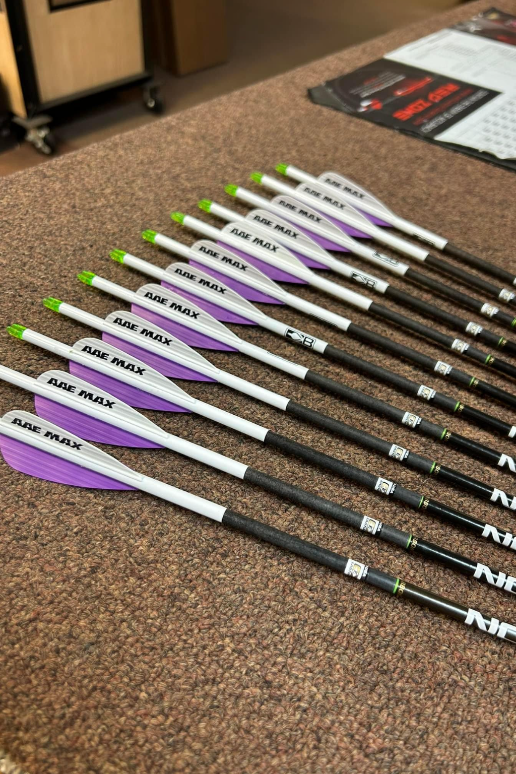 a bunch of arrows are lined up on a table