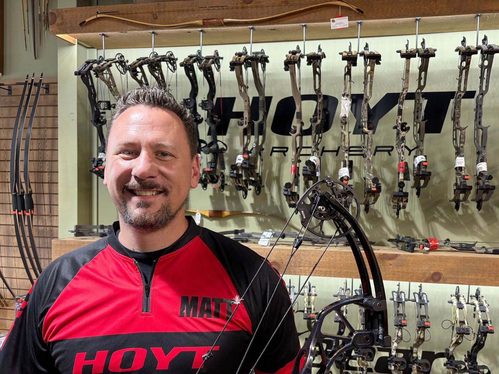 A man in red Hoyt archery shirt
