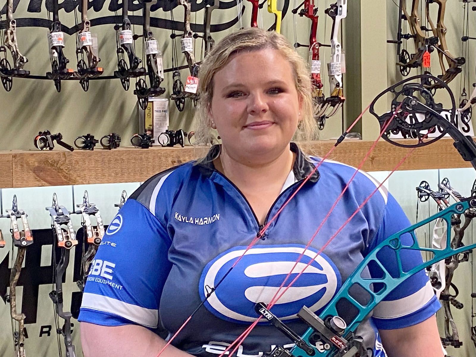 A woman in blue archery shirt