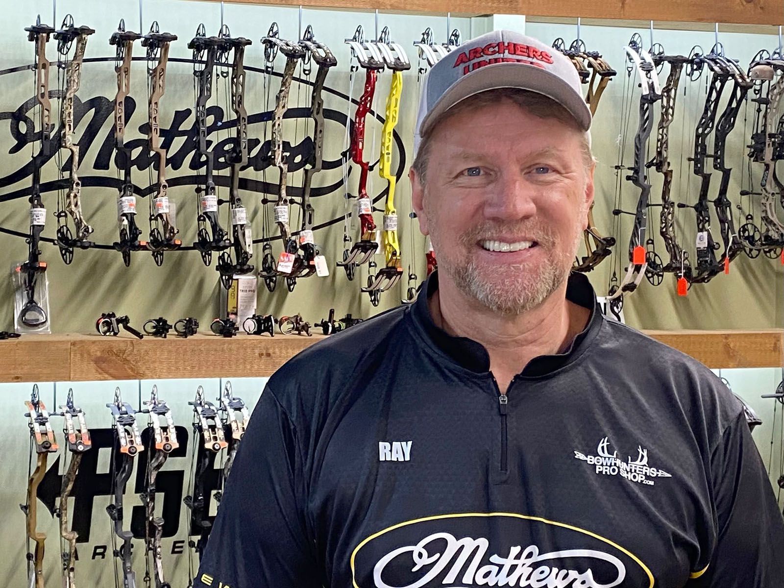 A man in black archery shirt with a cap