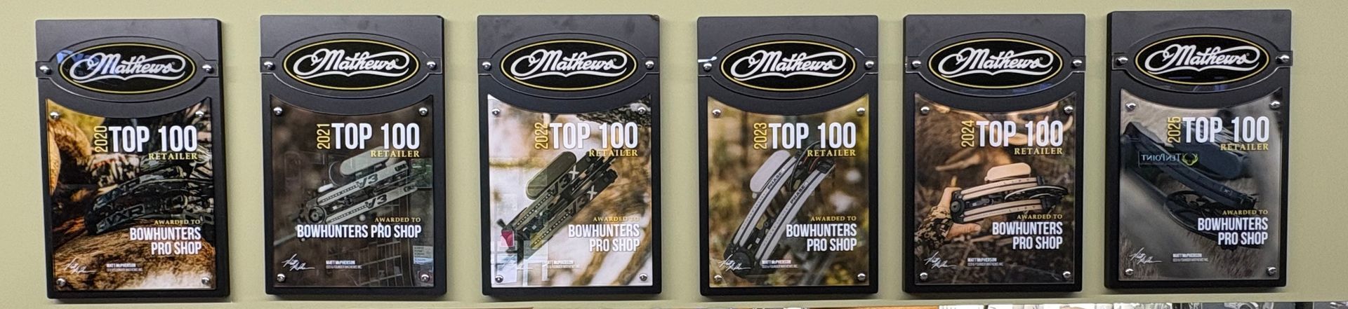 Six black product packages lined up, each with white text and a photo of food or beverage on the front.