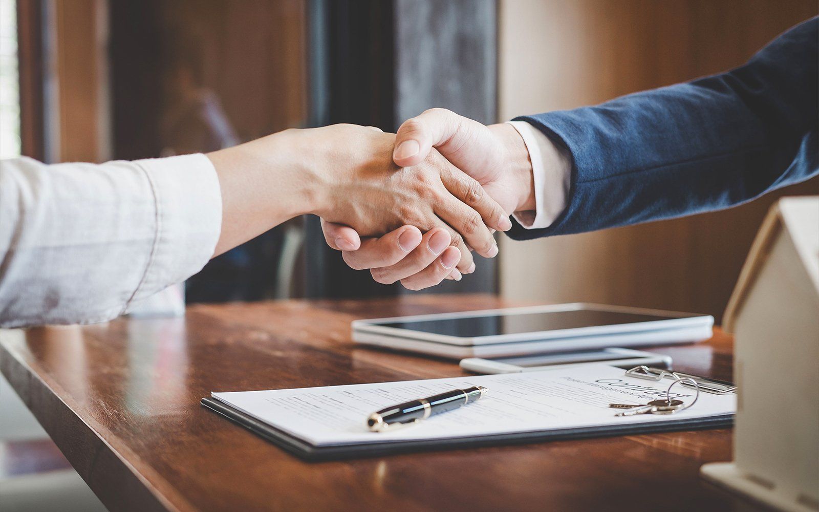 Insurance agent shaking hand with a client