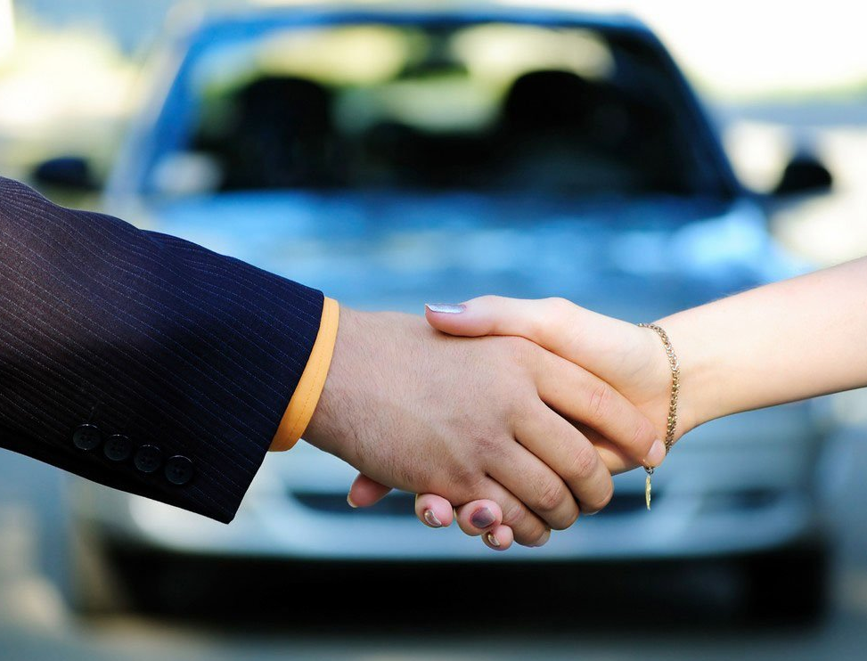 Handshake with fixed  car in background