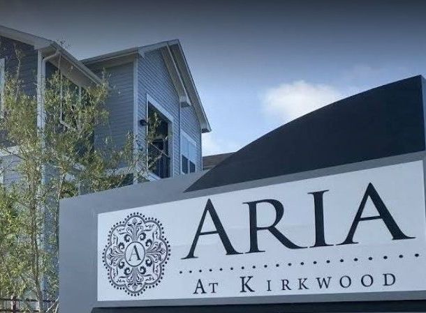 A large building with a sign in front of it that says aria at kirkwood.