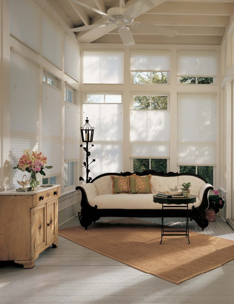 A living room with a couch and a ceiling fan