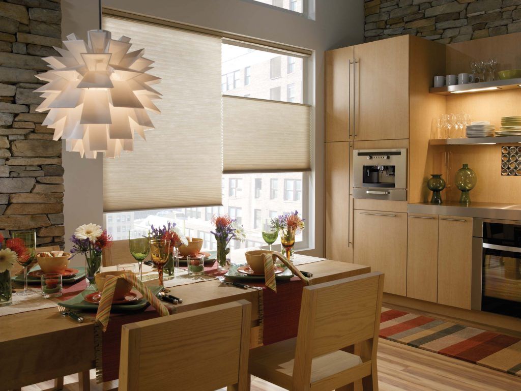 A dining room with a table and chairs and a lamp