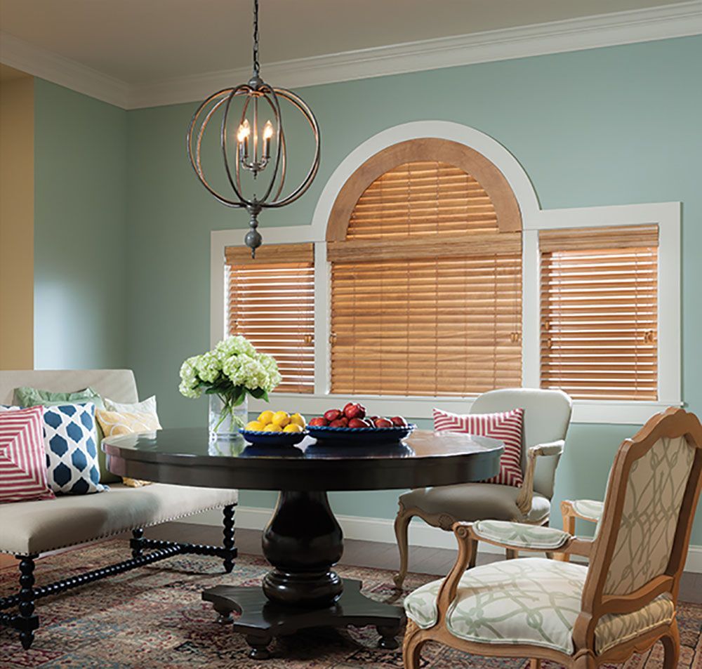 A dining room with a round table and chairs