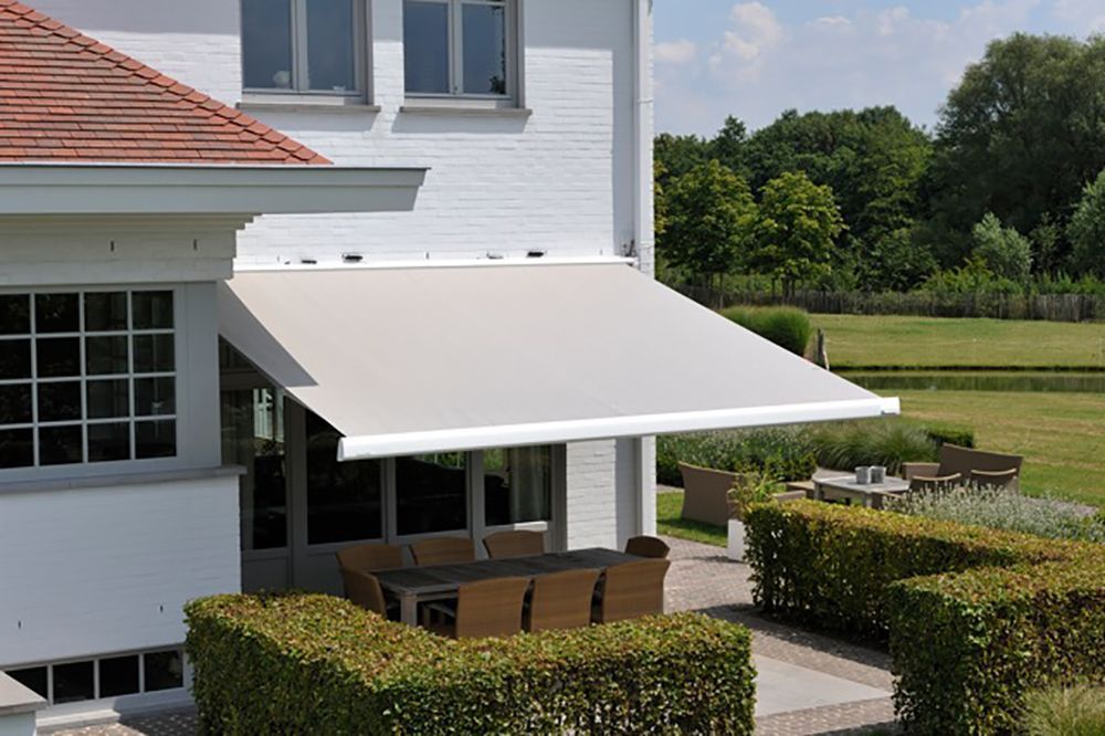 A white house with a white awning over a patio