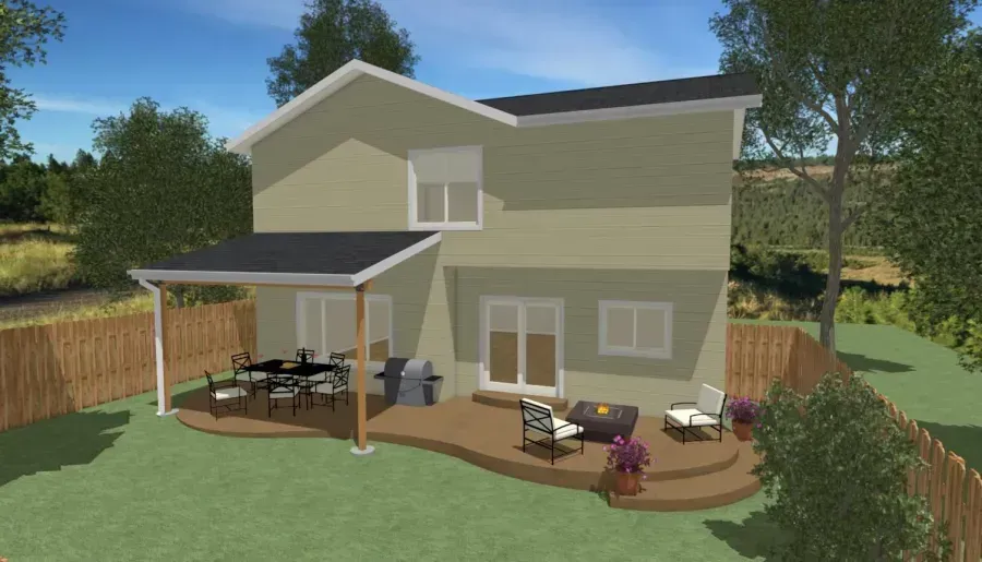 Two-story beige house with a backyard patio, deck chairs, umbrella, and wooden fence under a clear sky.