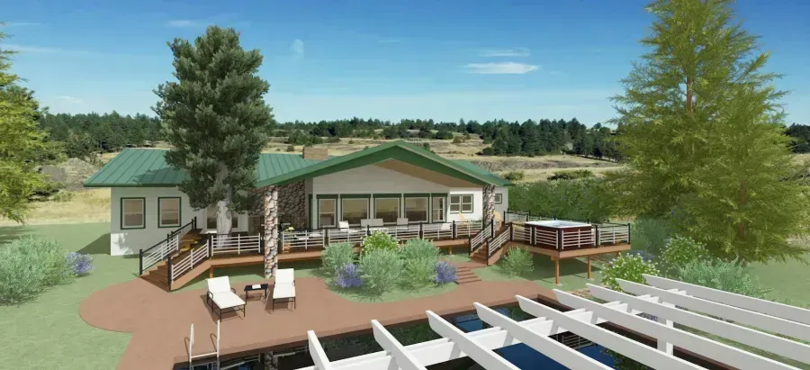 Modern lakeside house with deck, stairs, trees, and a green roof under a blue sky
