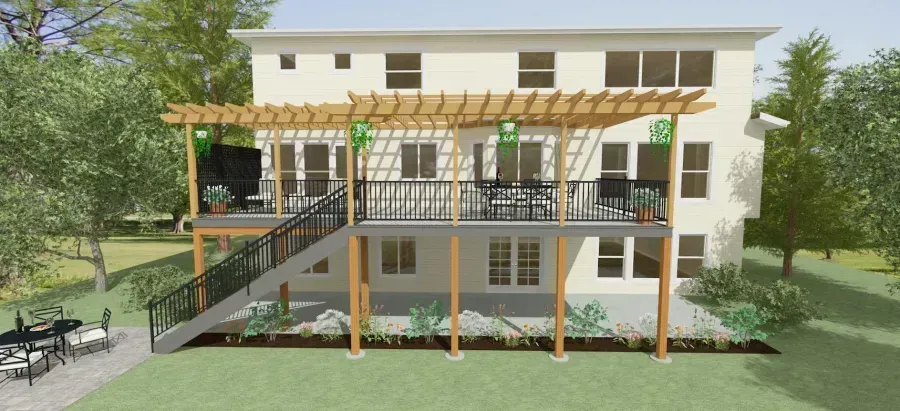 Front view of a two-story house with a wooden deck, ramp, and landscaped yard.