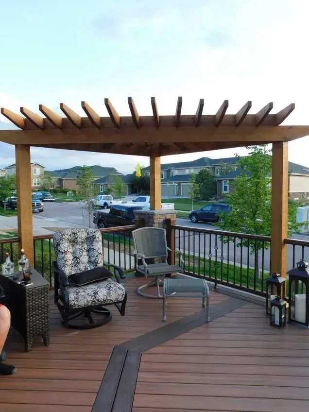 Covered patio with lounge chairs, pergola, and neighborhood street view.