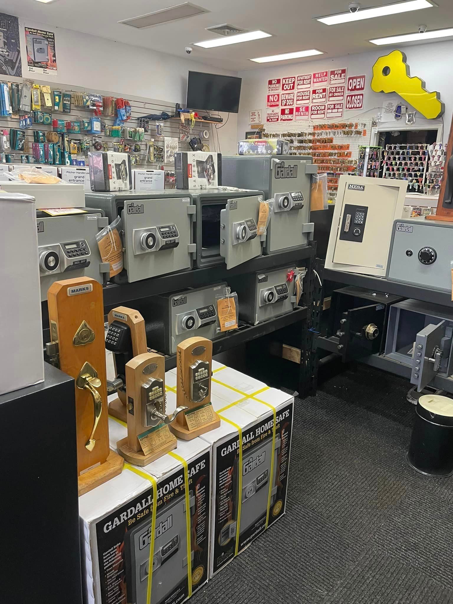 Locksmith store interior with safes, locks, and security equipment on display.