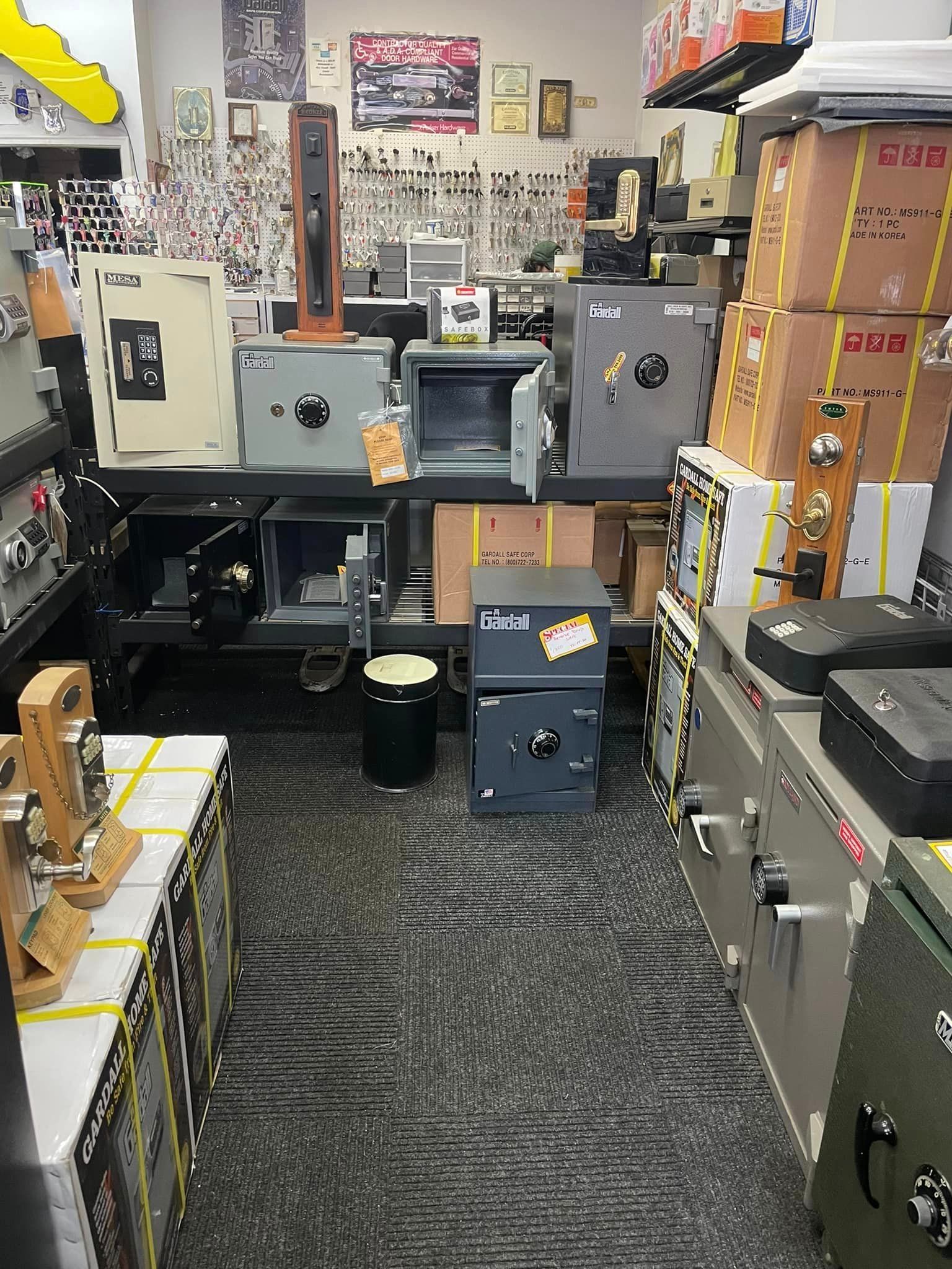 Interior of a security shop displaying numerous safes, locks, and related hardware on shelves and counters.