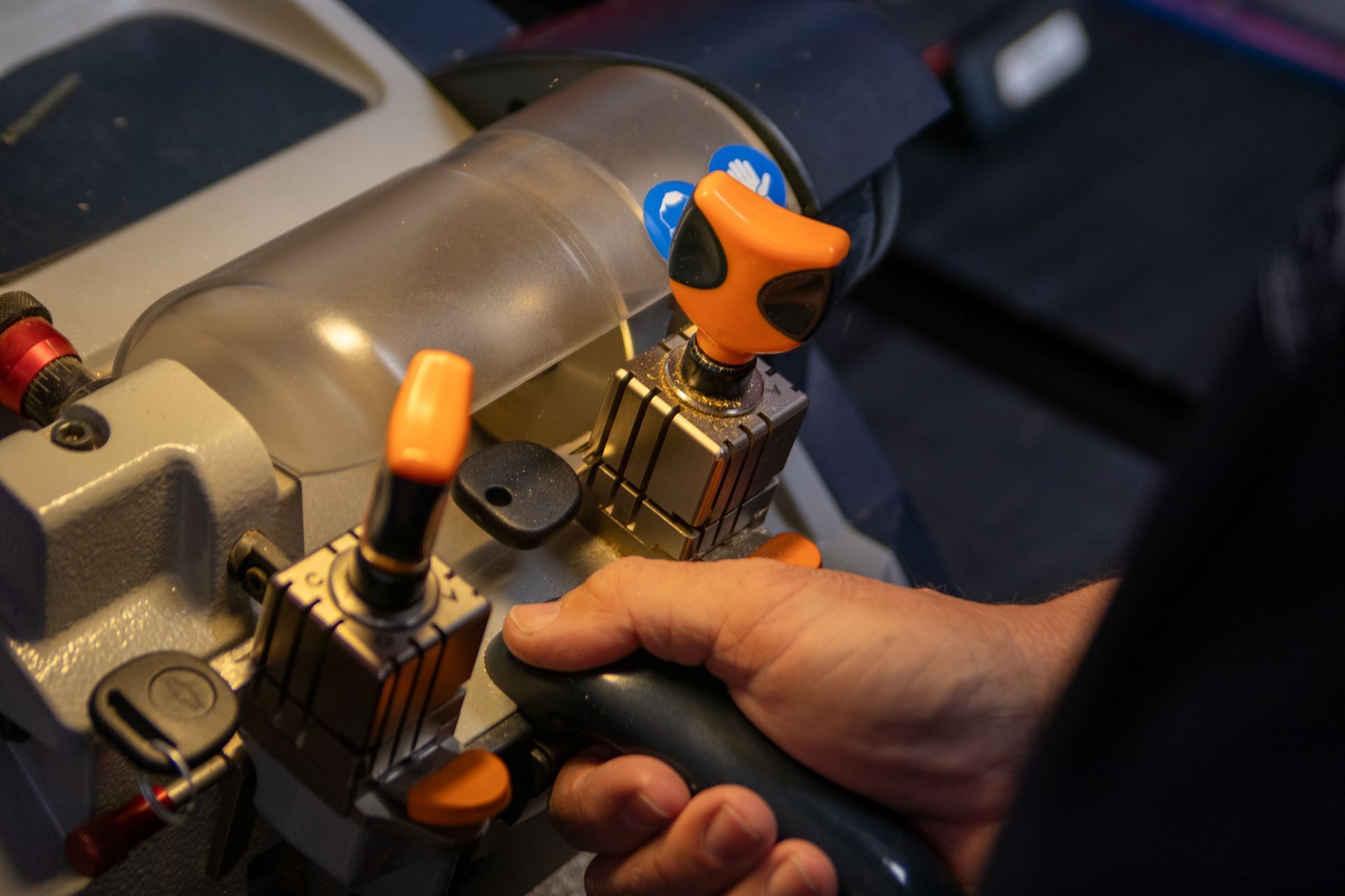 A person is using a machine to cut keys.