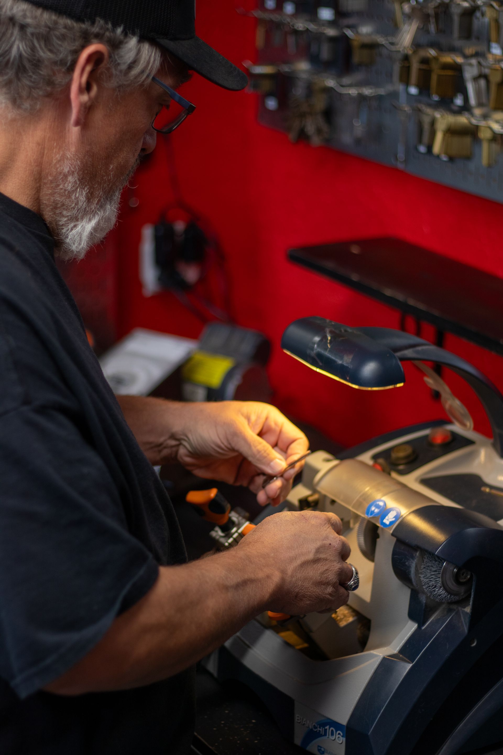 A man is using a machine to cut a key.