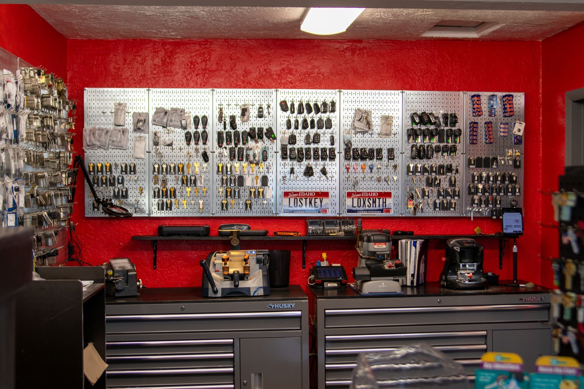 A bunch of keys hanging on a wall in a locksmith shop.