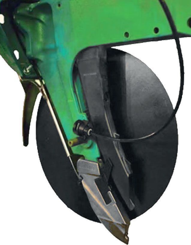 A close up of a green machine with a black wheel