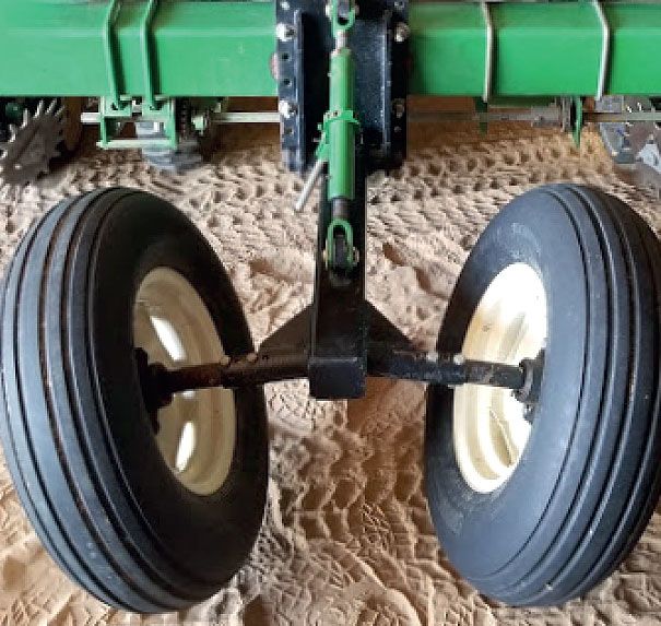 A close up of a wheel on a green tractor