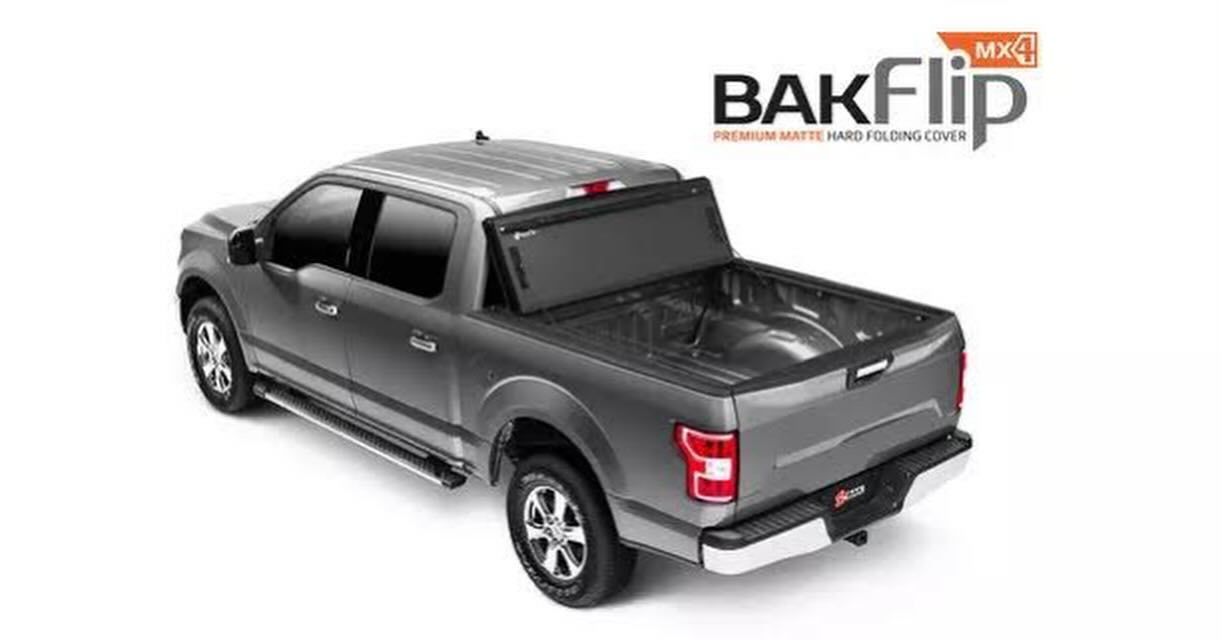 A gray truck with a bakflip bed cover on it.
