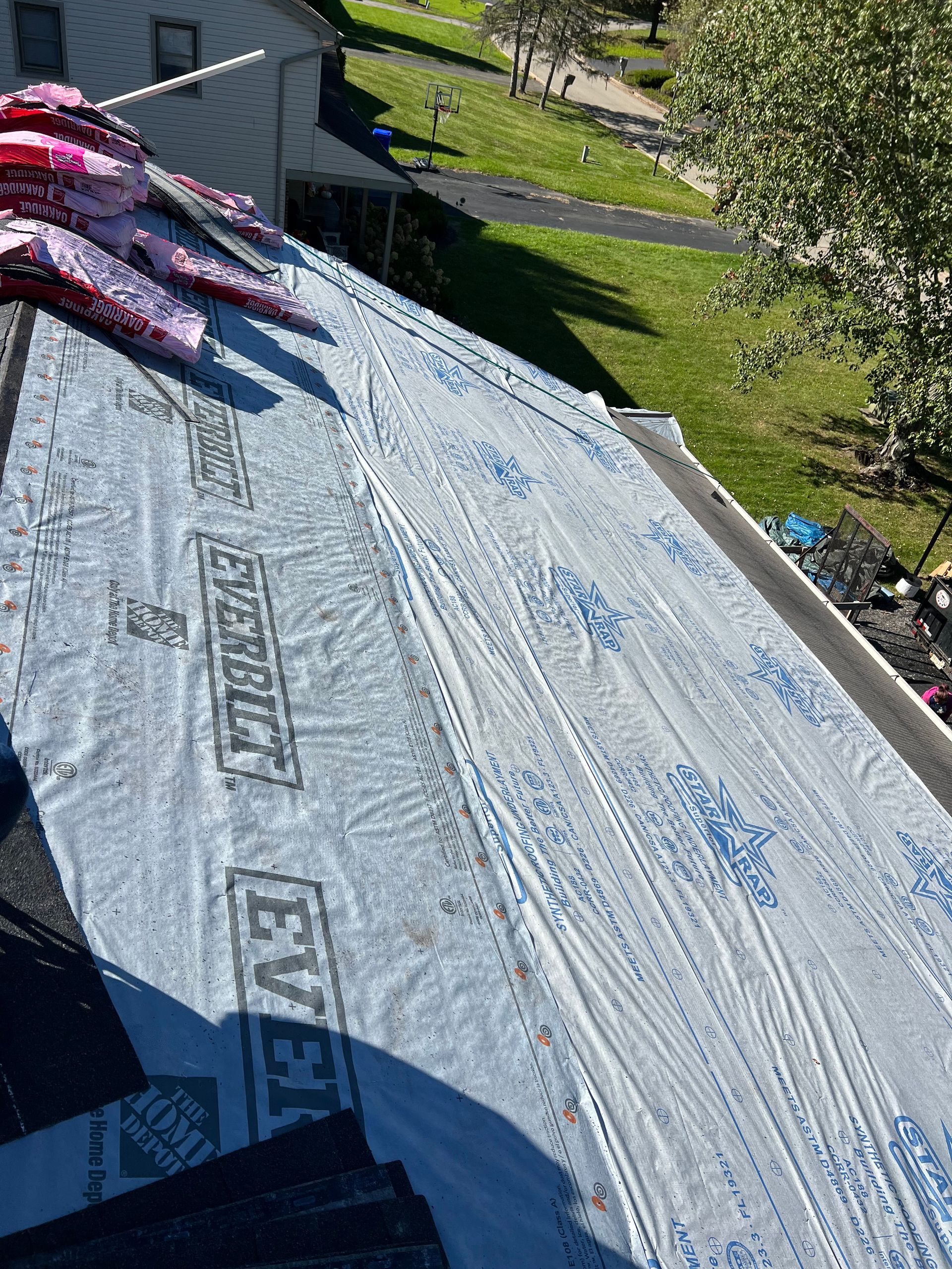 A roof with a lot of roofing material on it.