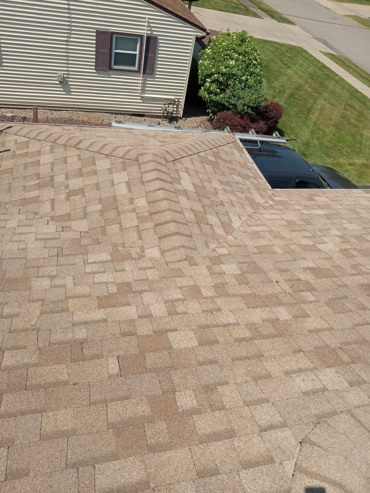 A roof of a house with a car parked on it.