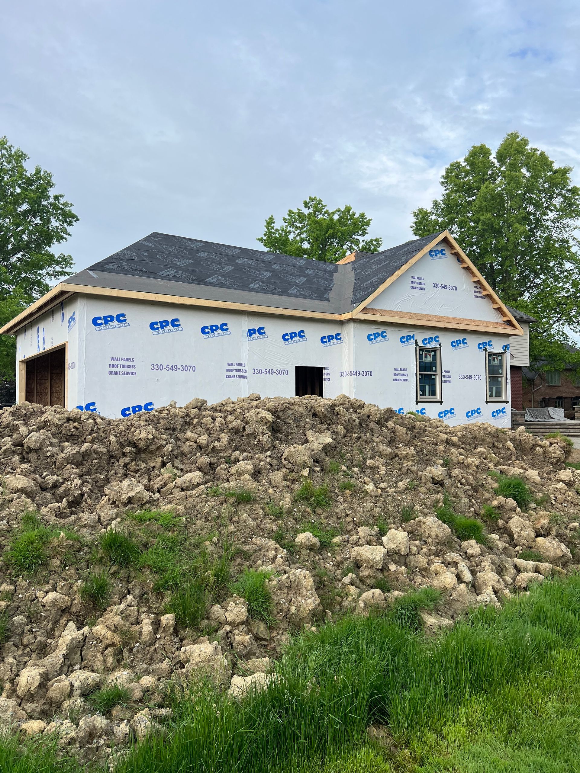 A house is being built on top of a pile of dirt.