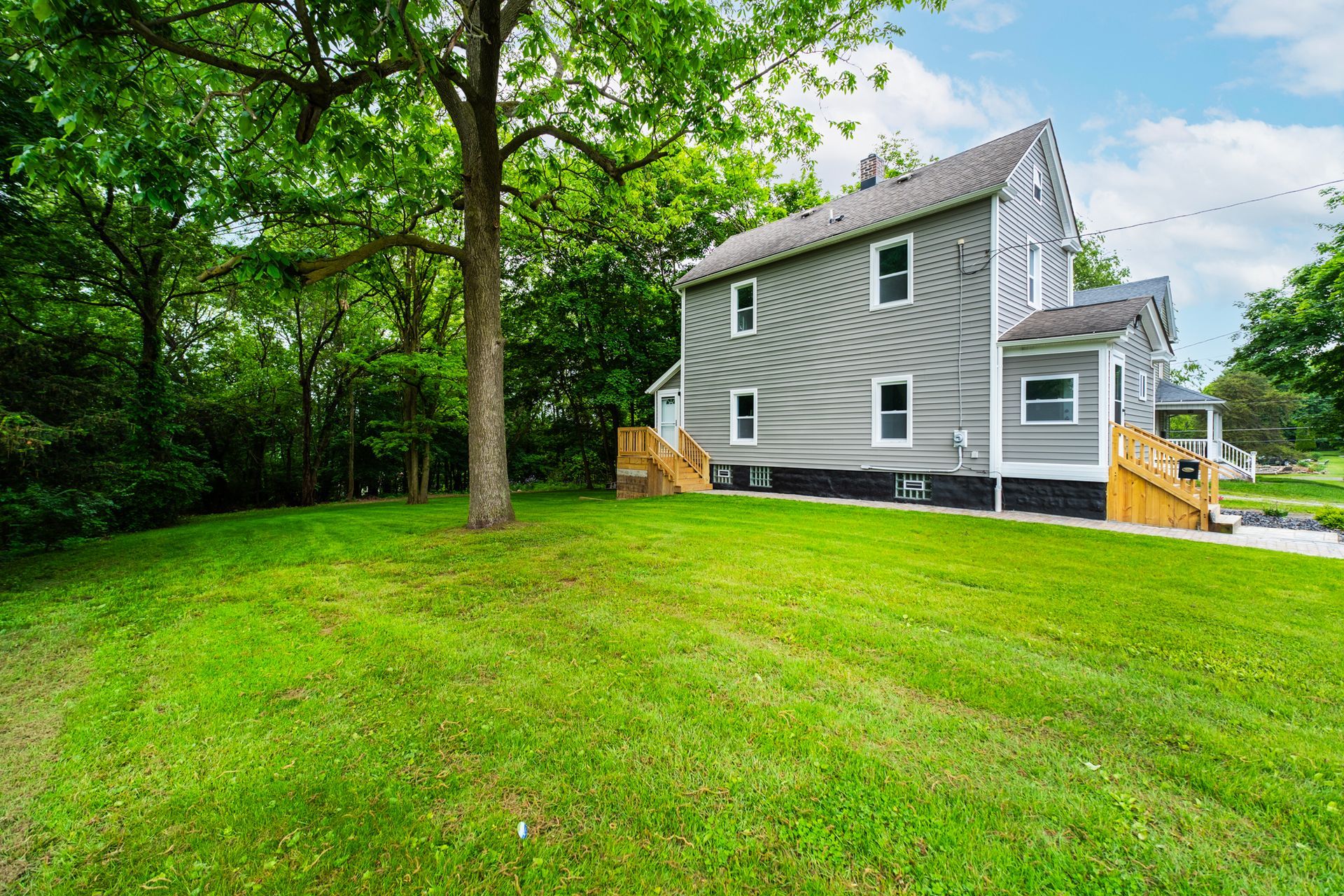 A large house with a lush green lawn in front of it.