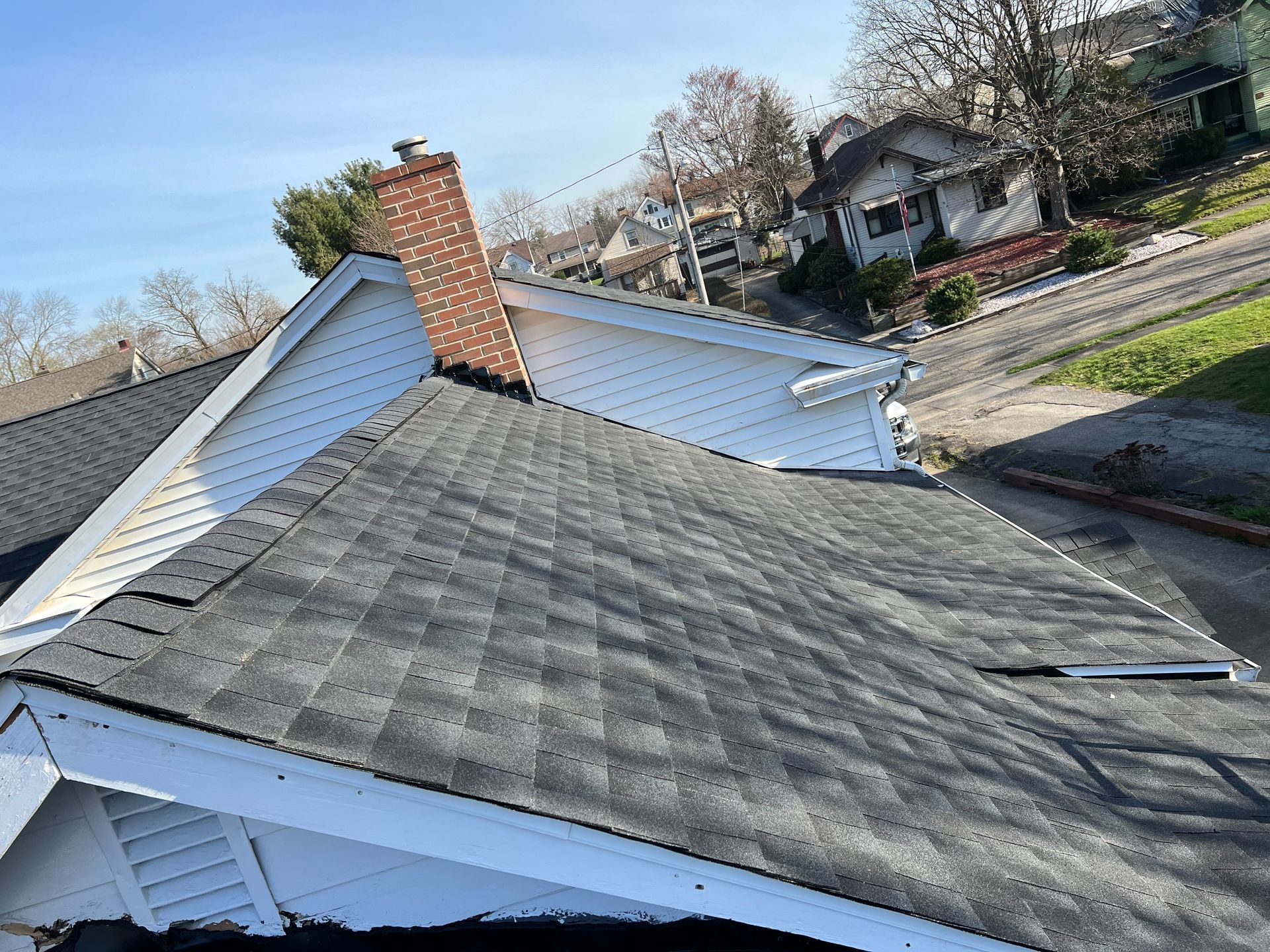 The roof of a house with a chimney on it.