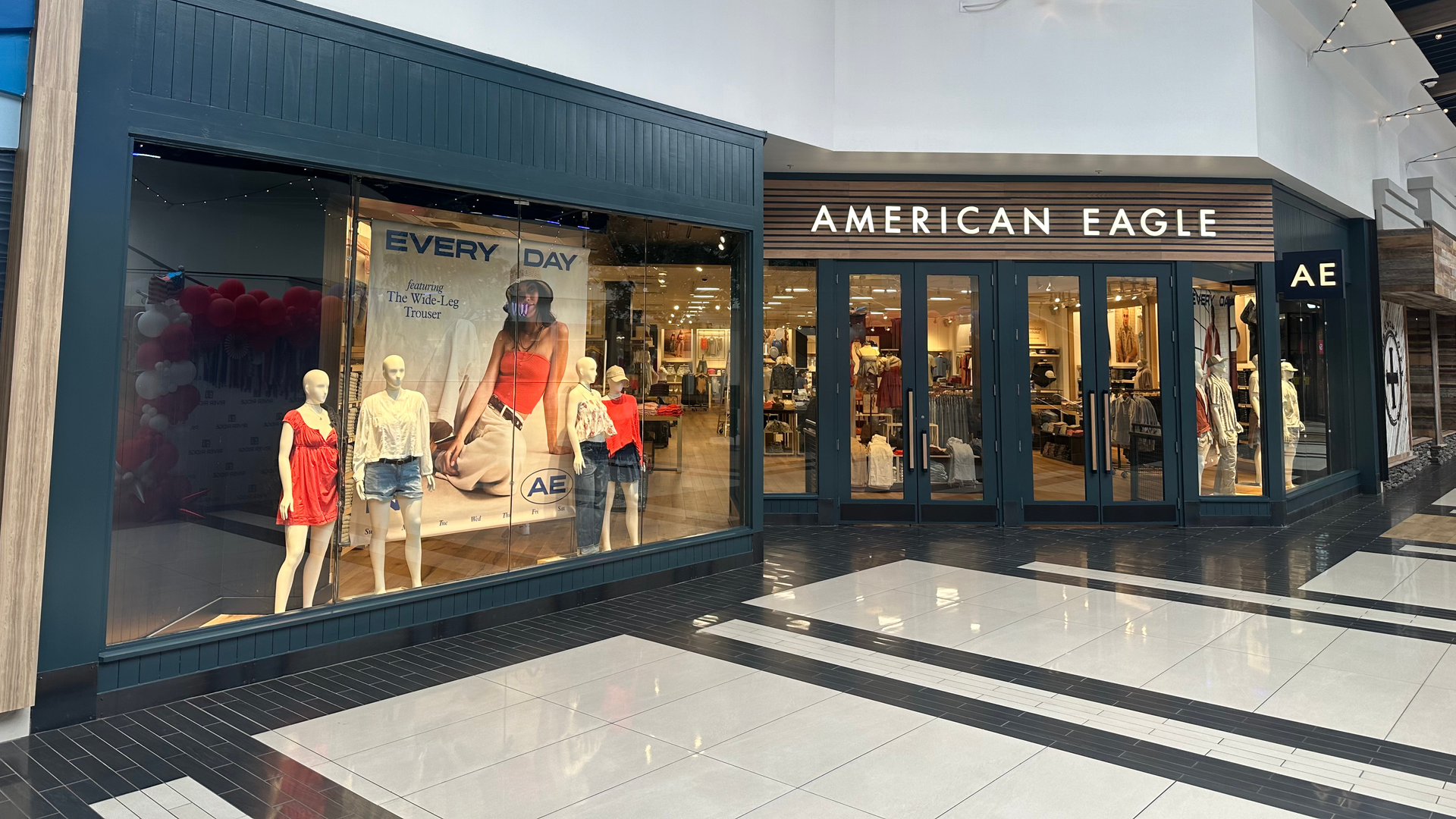 American Eagle storefront in a mall, with mannequins in the display window.