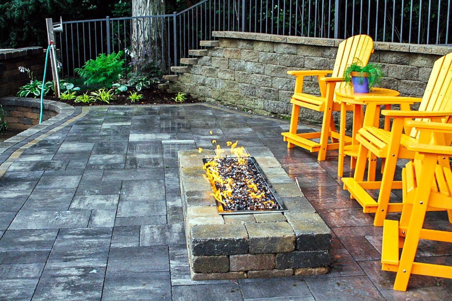 There is a fire pit in the middle of the patio.