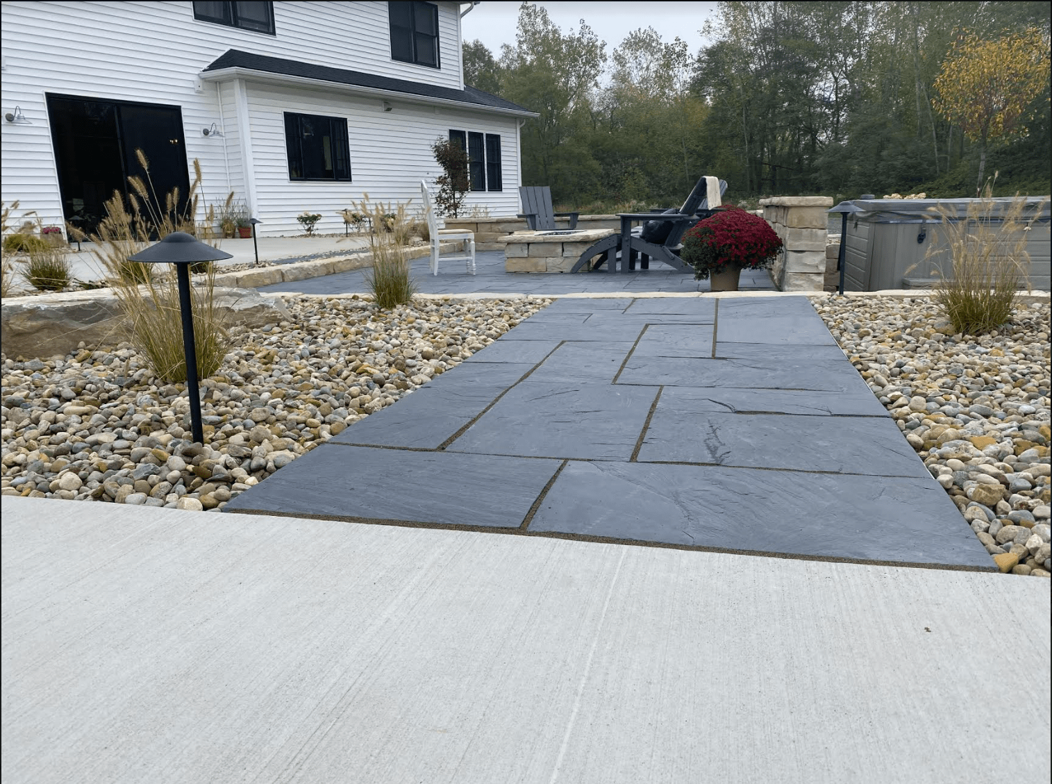 A stone walkway leading to a white house
