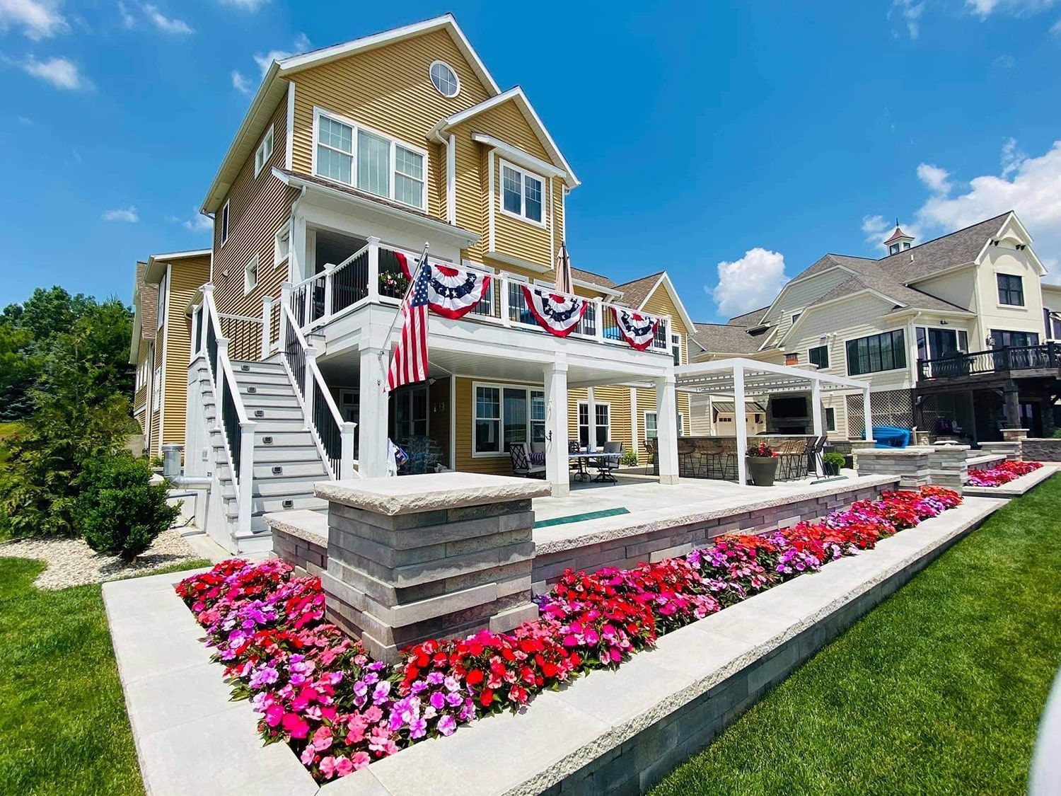 A large house with a lot of flowers in front of it