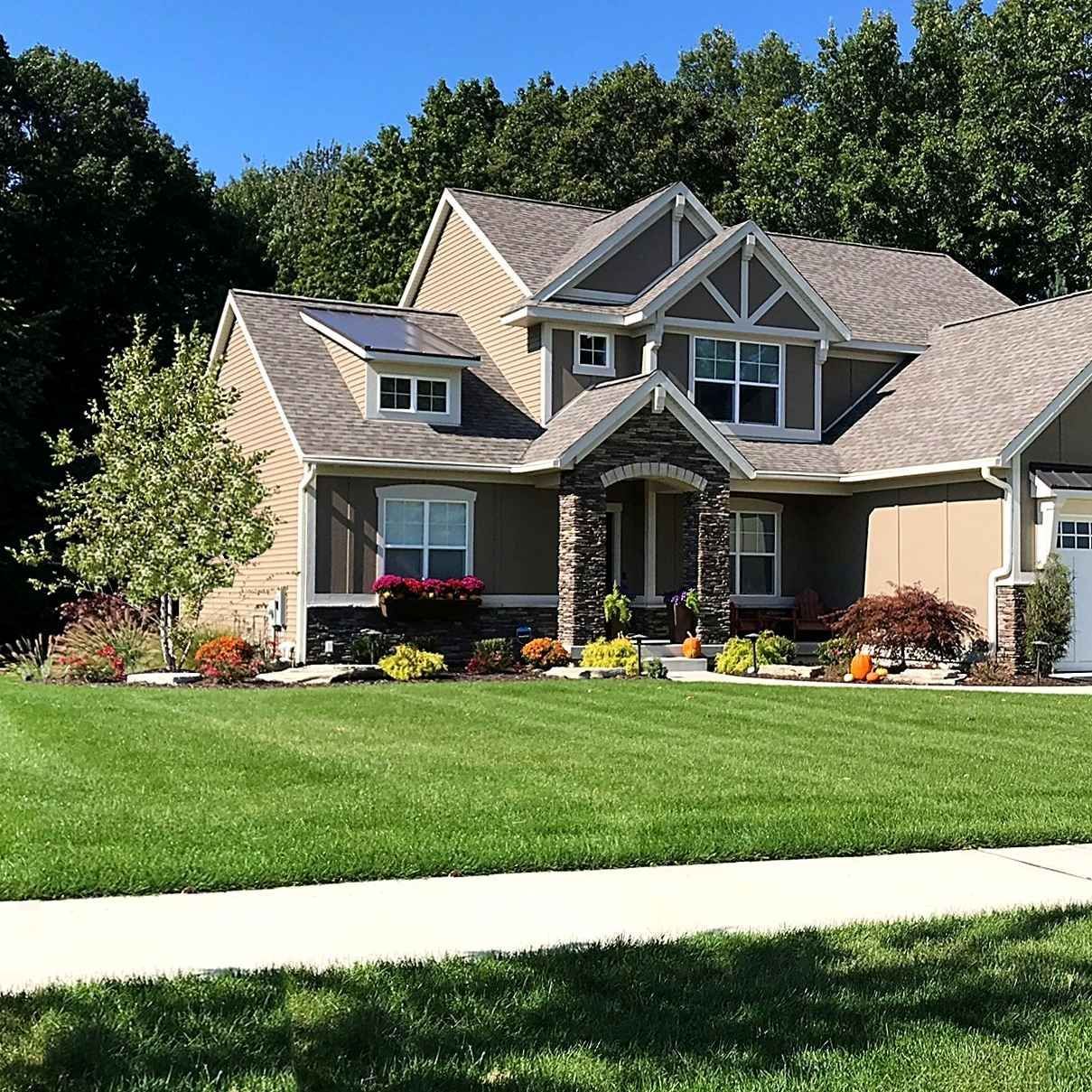 A large house with a lush green lawn in front of it.