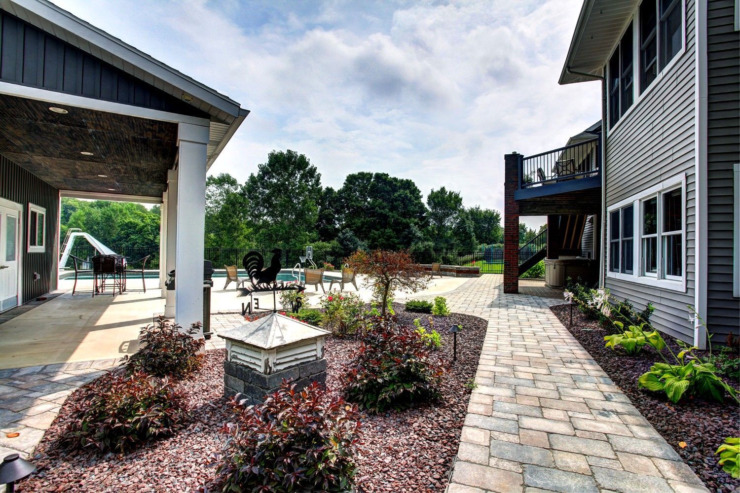 A large house with a patio and a walkway leading to it.