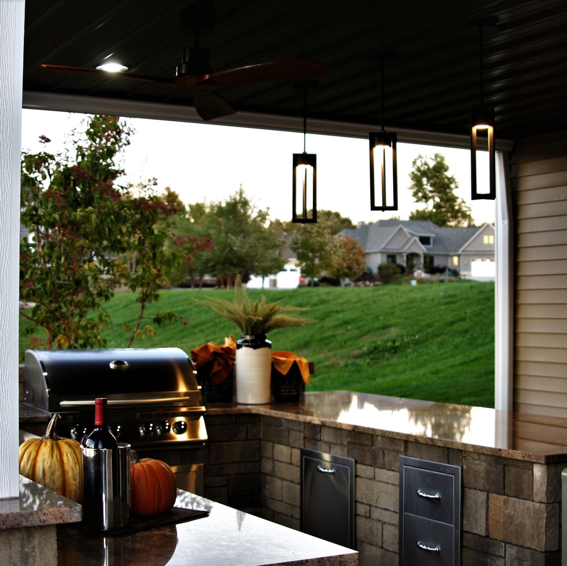 A kitchen with a grill and pumpkins on the counter