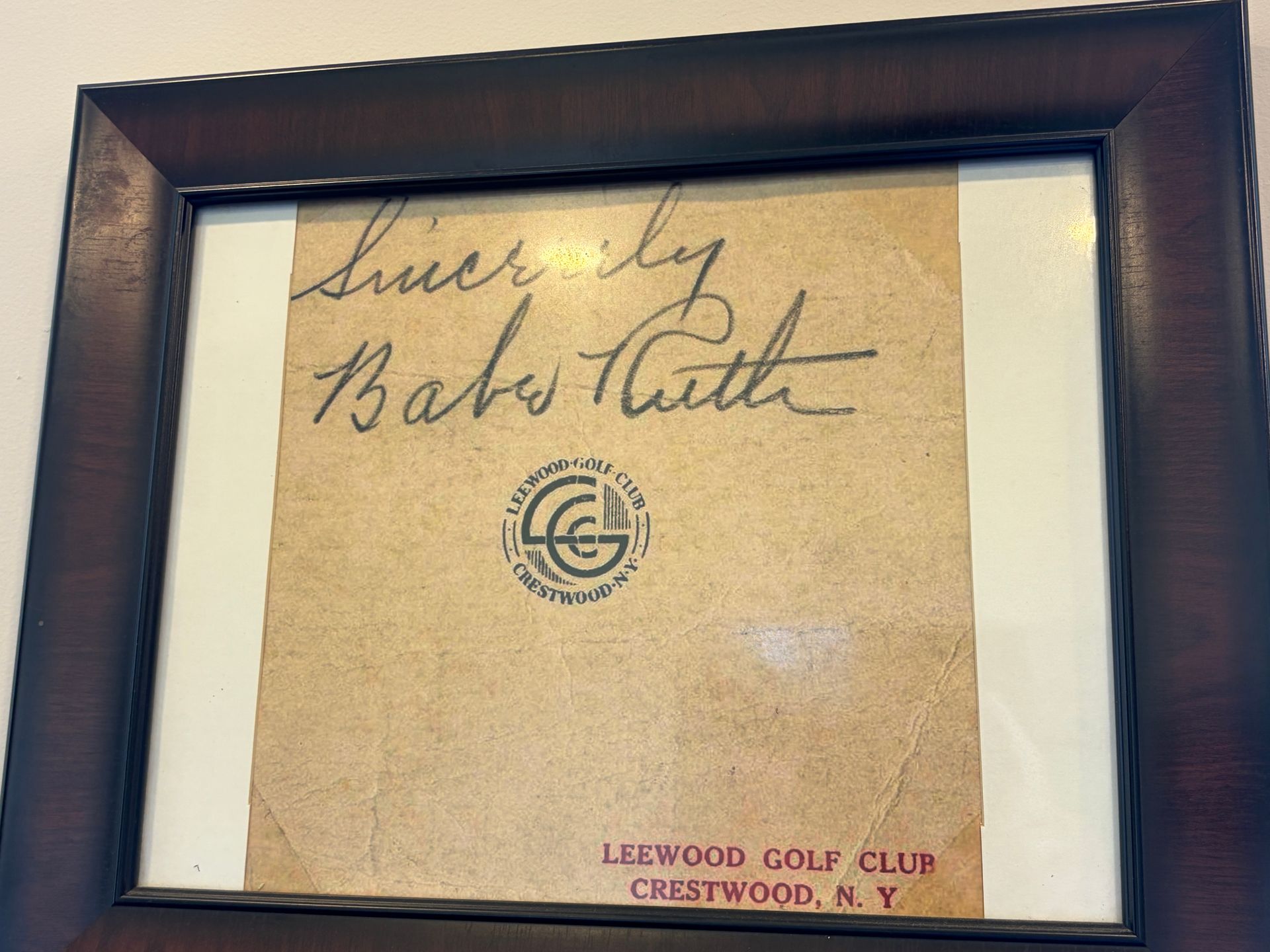 Framed signed card with “Babe Ruth” and “Lakewood Golf Club” text on tan paper