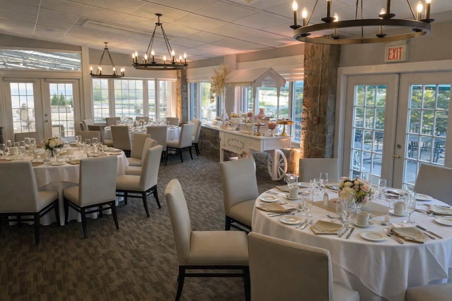 Elegant dining room with round tables, white linens, and chandeliers.