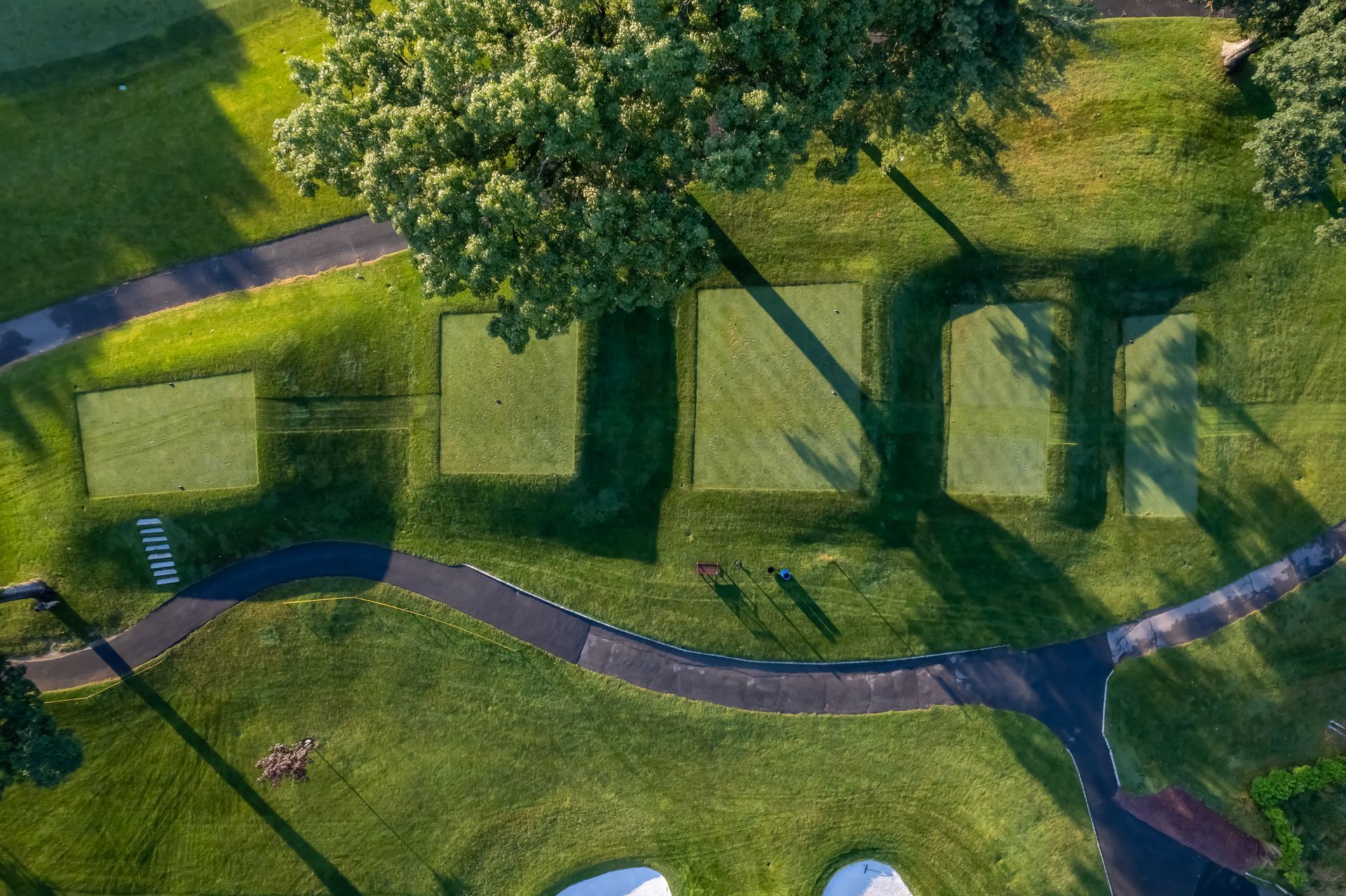 Aerial view of a green golf course with the word 