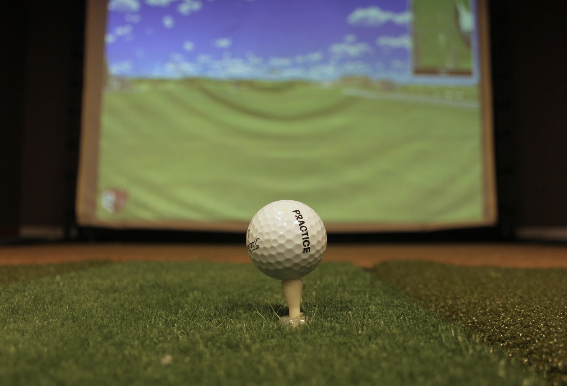 Golfers on a green course, practicing their swing. Trees in the background, cloudy sky.
