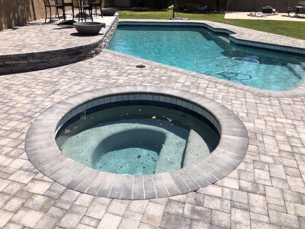 There is a hot tub in the middle of the pool.