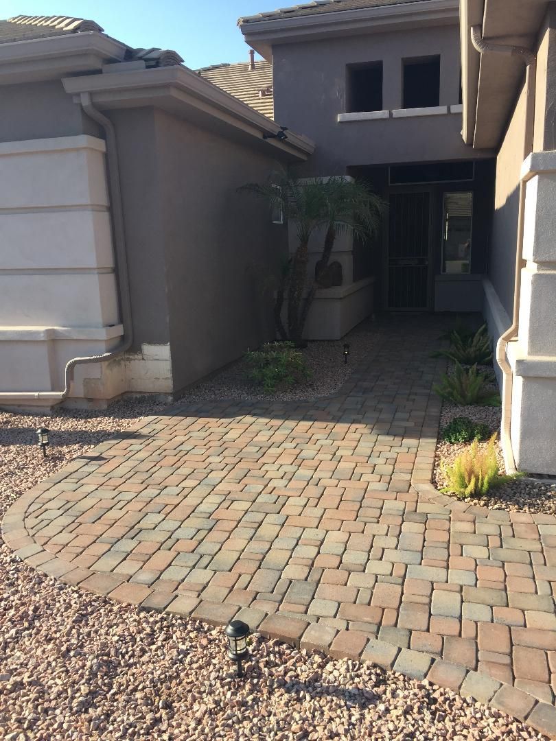 A house with a brick walkway leading to it
