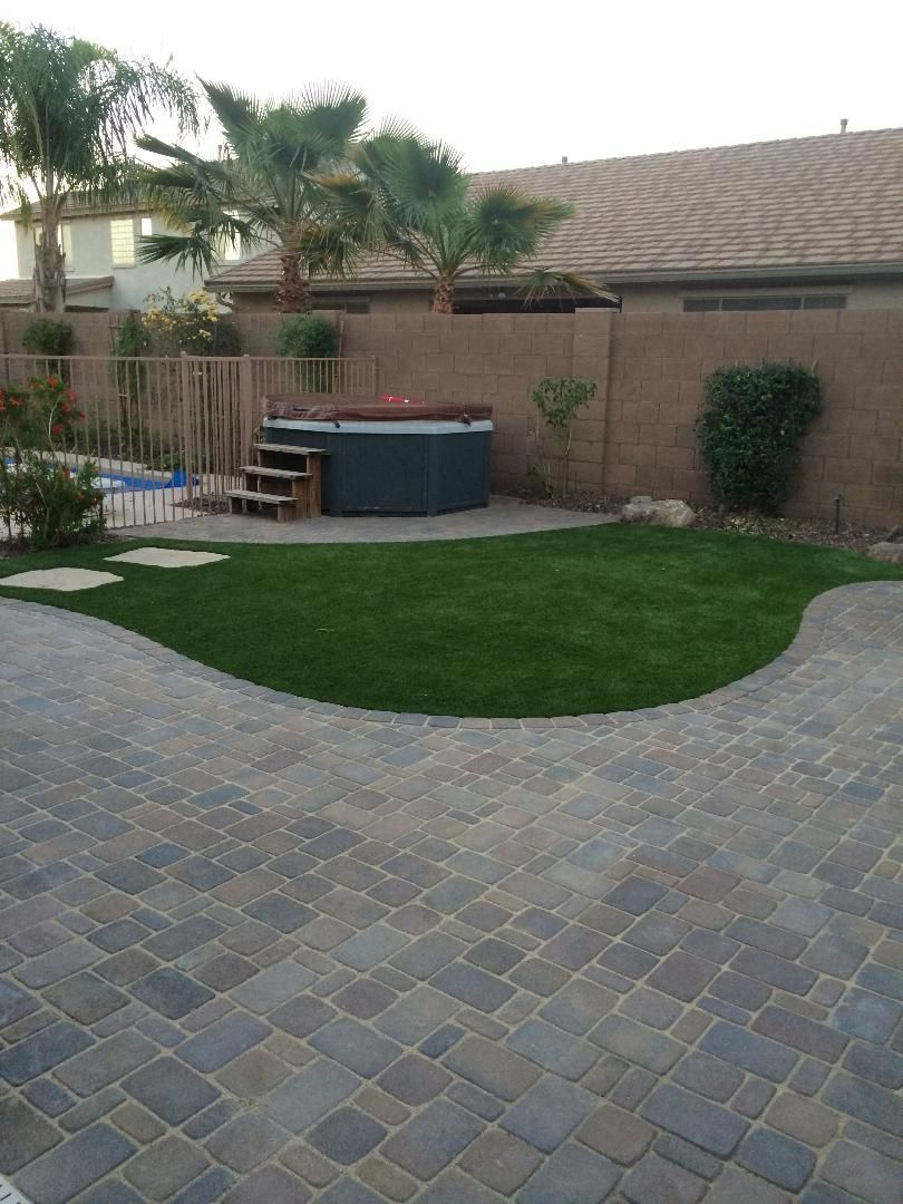There is a hot tub in the backyard of a house.