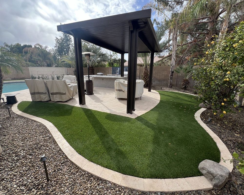 A backyard with a pergola and a swimming pool.